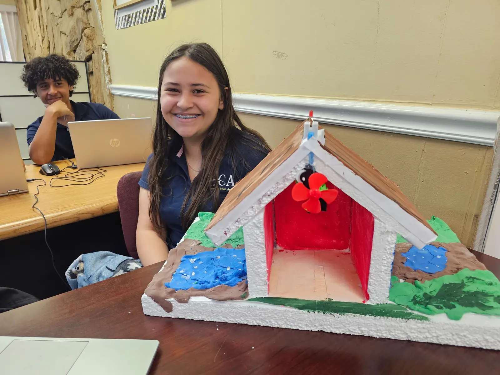 Student displaying a creative project