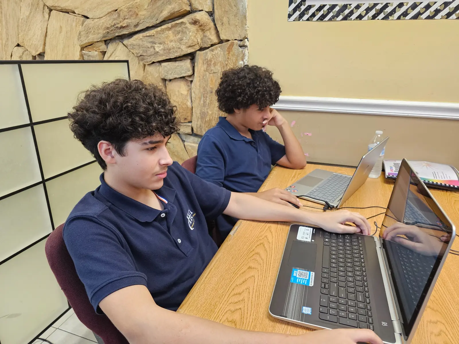 High school students working on laptops